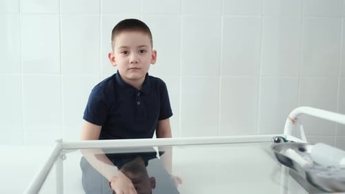 portrait boy sitting in medical treatment room