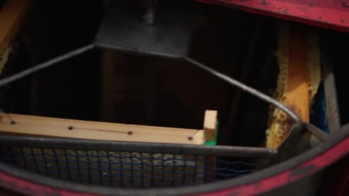 Close-up of a honeycomb extractor spinning honeycombs. Slow motion 120p