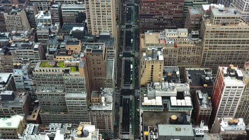Drone overview of traffic on a quiet street in cloudy Midtown, New York, USA