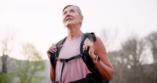 Forest, mature woman and thinking on hiking for fitness as adventure, exercise