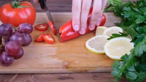 Hands Slicing Red Bell Pepper Into Rings
