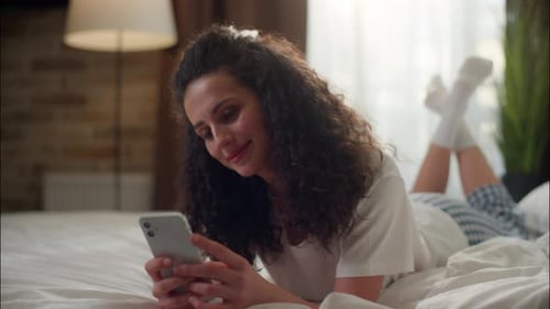 Woman Using Mobile Phone in Bedroom Shopping Girl Smartphone on Bed Cellphone Gadget Addicted