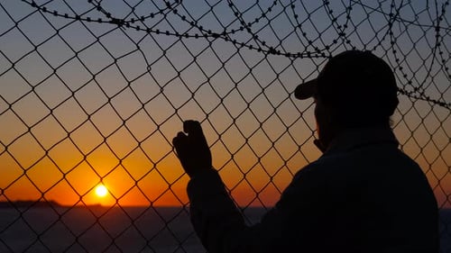 Refugee at Sunset Near the Border