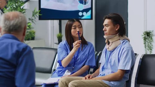 Healthcare Worker Talking to Young Adult Wearing Neck Brace