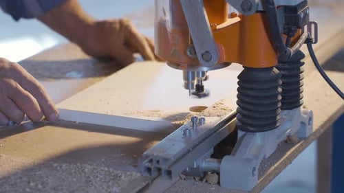 Woodworking Machine Cutting Piece of Wood in Workshop