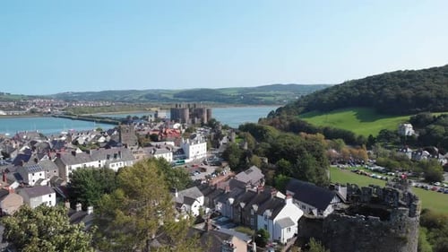 Drone flight over the ruins of Conwy castle and the town cottages, Wales.
