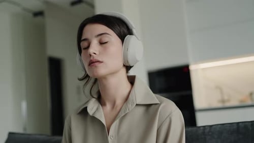 Woman Relaxing at Home With Headphones On