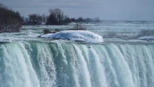 Static close-up of snowy iceberg top of waterfall Niagara falls winter slow motion