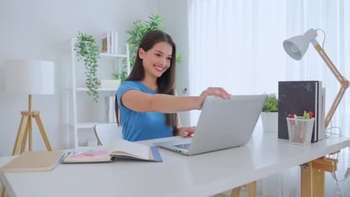 Young Woman Opens Laptop and Begins to Type