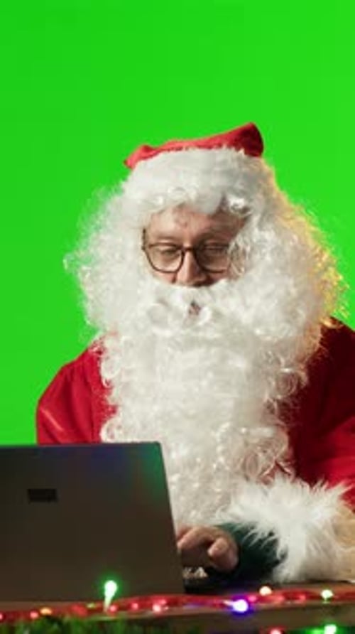Vertical Video Old Man Father Christmas Reading Wishes for Toys Against to Mockup Copy Space