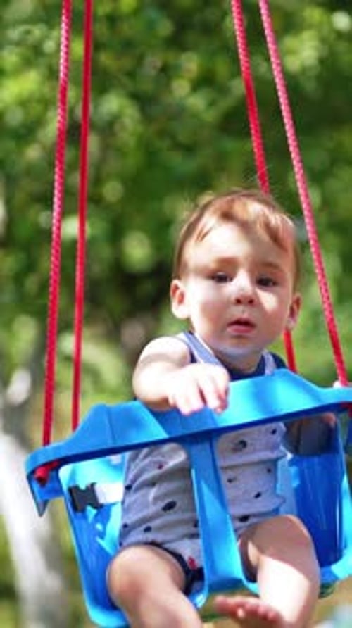 Adorable Infant Enjoying Gentle Swing Outdoors