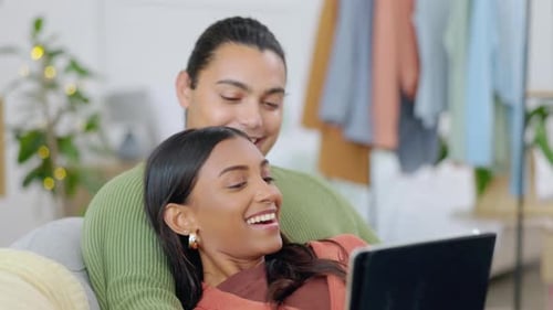 Couple Relaxing at Home with a Tablet