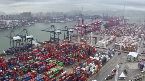 Fly above large logistic areal in harbour. Thousand of containers waiting for delivery to customer.