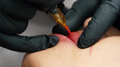 microblading lip tattoo 4k in a permanent makeup clinic, applying coloring pigment to lips with a ta