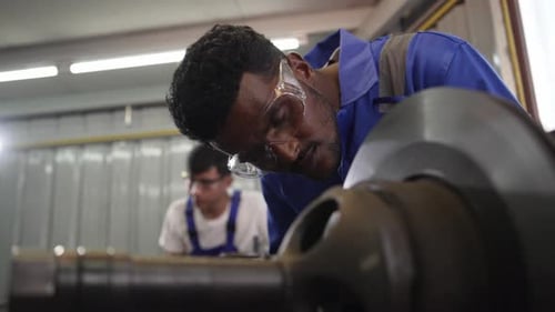 Workers Operating Heavy Machinery in an Industrial Workplace
