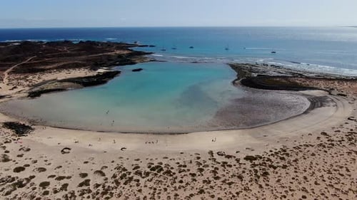 Aerial shot of La Concha beach on Lobos Island. Turquoise beach. It belongs to the Canary Islands an