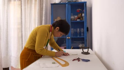 Creative fashion designer drawing models of exclusive dress collection