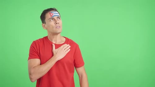 Man Listening to the Cuba National Anthem with Solemnity