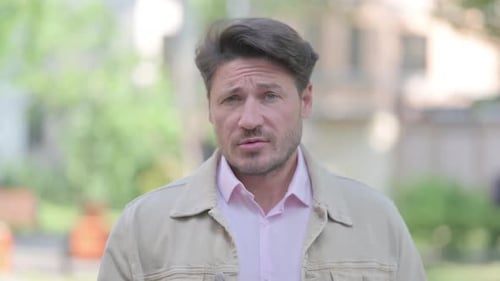 Dark Haired Adult Looking into Camera