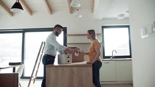 A Young Couple Moving in New Home, Unpacking Stuff