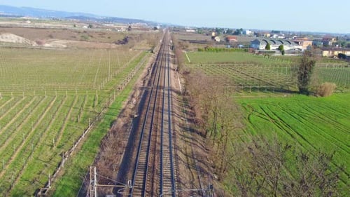 Aerial View of Straight Railway Tracks Through Rural Vineyards