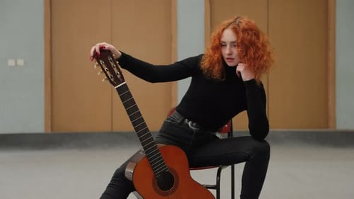 Woman with Guitar Posing Indoors