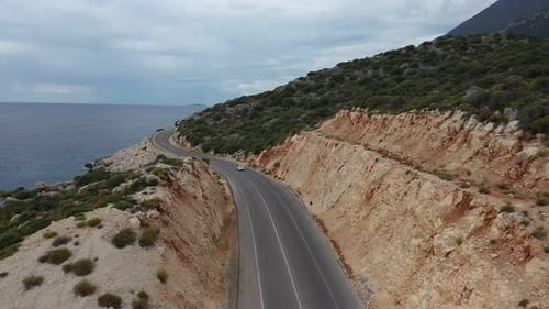 Aerial View of Car Driving Beautiful Road Along the Aegean Sea Coast