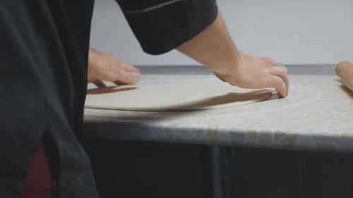 Close Up Male Arms of Cook Forming Pastry on a Wooden Surface at Cuisine Hands of Chef Shaping
