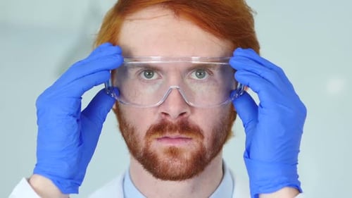 Close Up of Redhead Scientist Doctor Wearing Protective Glasses