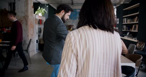 Camera Follows Confident Caucasian Middle Aged Woman Taking Job Interview with Young Male HR at Loft