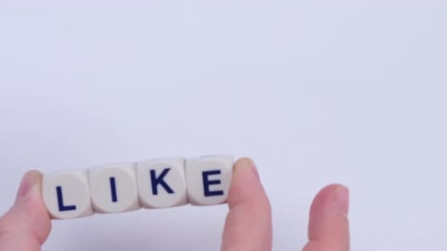 Hands Spelling Out LIKE with Dice