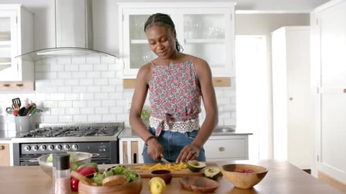 Woman Preparing Fresh Salad in Bright Kitchen