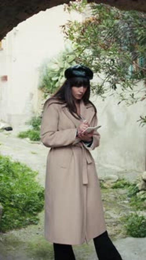 Woman Under The Arch Of A Medieval Town Taking Notes