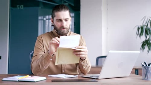 Excited Man Reads Letter With Great News