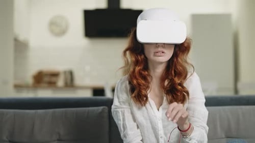 Woman Experiencing Virtual Reality on a Couch