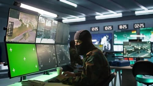 Special Forces Spy Examining Data in Monitoring Room with Chroma Key Monitors