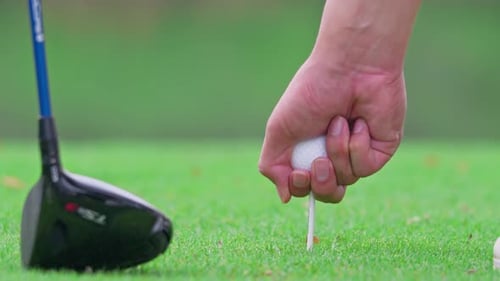 Close up of professional golfer swinging club on a scenic golf course.