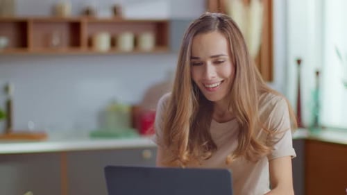 Excited Businesswoman Receiving Good News on Laptop Computer at Home Workplace. Close