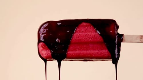Delicious Dessert: Dark Chocolate Drizzled on a Red Popsicle
