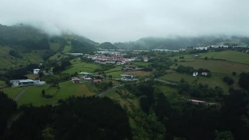 Cinematic winding mountains and village buildings