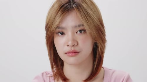 Slow motion shot close up face of Young Asian girl on white background.