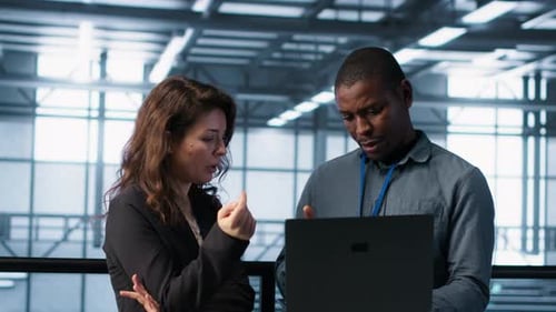 Engineers Using Laptop in Data Center Managing Server Virtualization