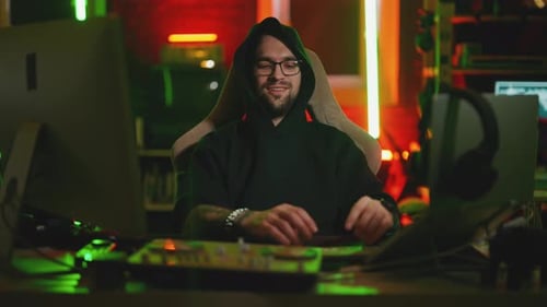 Hacker Writing Code Cracking Computer Man Programmer in Hoodie Cracks System Using Computer in Dark