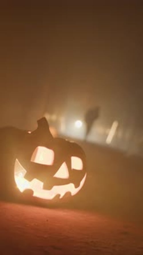 Glowing Halloween Pumpkin with Spooky Background Figure