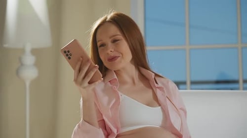 Pregnant Woman Using Phone at Home