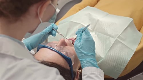 Dentist Doing Dental Examination of Patient in Clinic