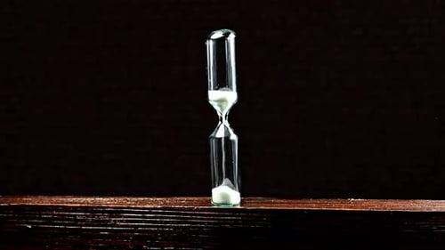 Sand clock on wooden background