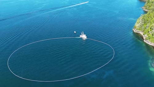 Aerial view of fishing boat with net in water, United States.