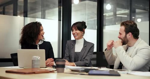 Business team laughs in office meeting