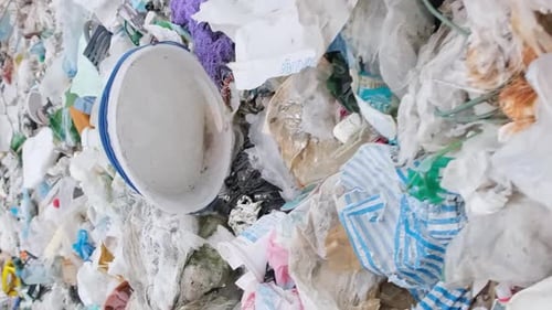 The Beach is Littered with Empty Dirty Plastic Bottles and Various Chemical Wastes Vertical Video